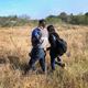 A father carries his sleeping son, 3, after their family illegally crossed the U.S.-Mexico border on December 7, 2015 near Rio Grande City, Texas